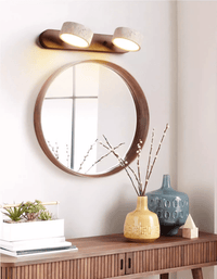 Applique en travertin finition noyer au-dessus d'une console et d'un miroir rond