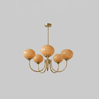 Lustre cinq lumières finition cuivre et abat-jours orange