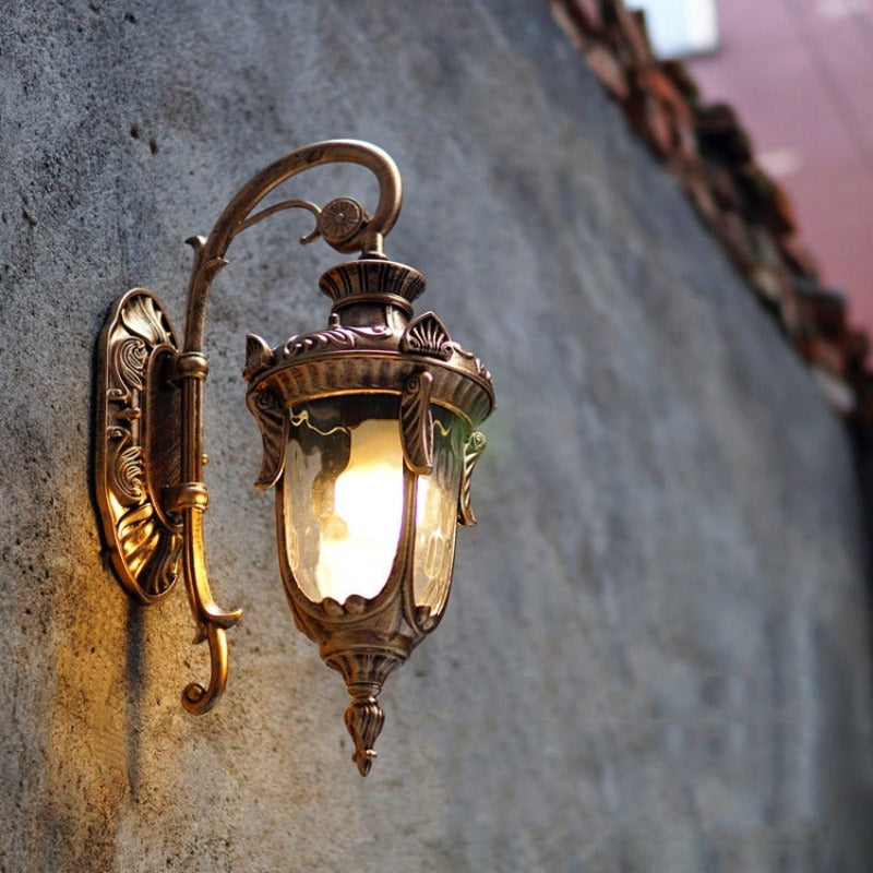 Applique murale extérieure vintage bronze sur un mur en pierre extérieur