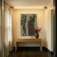 Applique murale LED linéaire éclairant un couloir avec console en bois et tableau