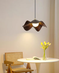 Suspension design organique au-dessus d'une table ronde avec chaise en cannage