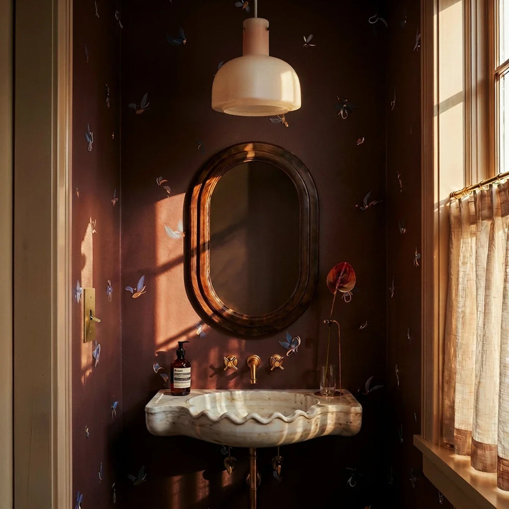 Interrupteur vintage en laiton dans une salle de bain aux murs prune