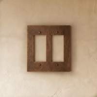 Plaque interrupteur en laiton vieilli 2 postes sur mur clair